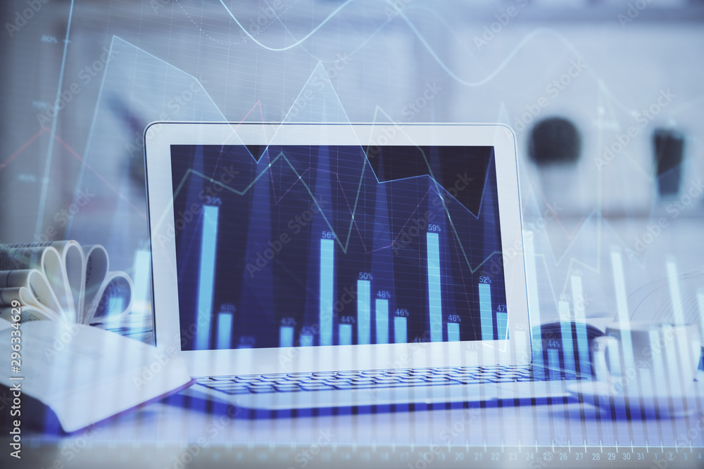 Forex Chart hologram on table with computer background. Multi exposure. Concept of financial markets. Forex Chart hologram on table with computer background. Multi exposure. Concept of financial markets.
