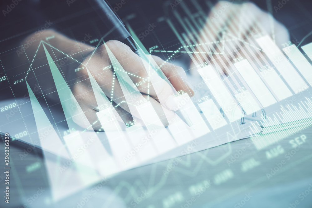Forex graph on hand taking notes background. Concept of research. Double exposure Forex graph on hand taking notes background. Concept of research. Double exposure