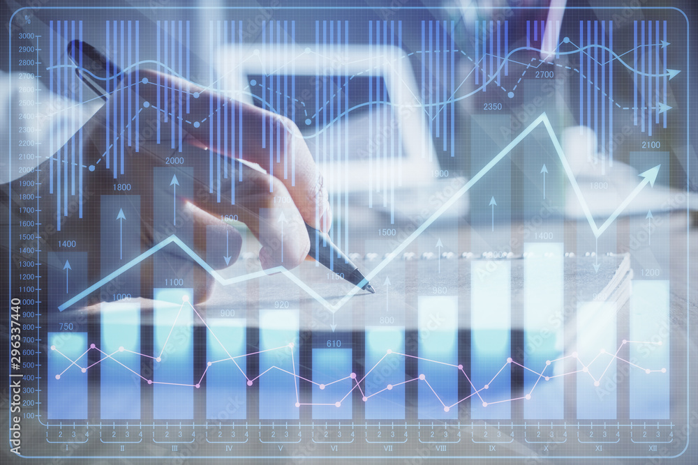 Financial charts displayed on woman's hand taking notes background. Concept of research. Double exposure Financial charts displayed on woman's hand taking notes background. Concept of research. Double exposure
