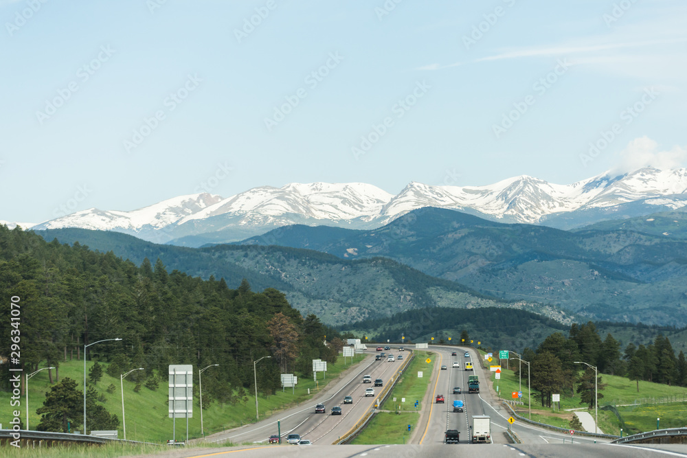 American highway going through snow capped mountain landscape