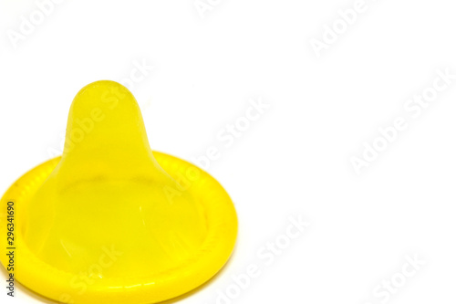 Yellow latex condom on white background