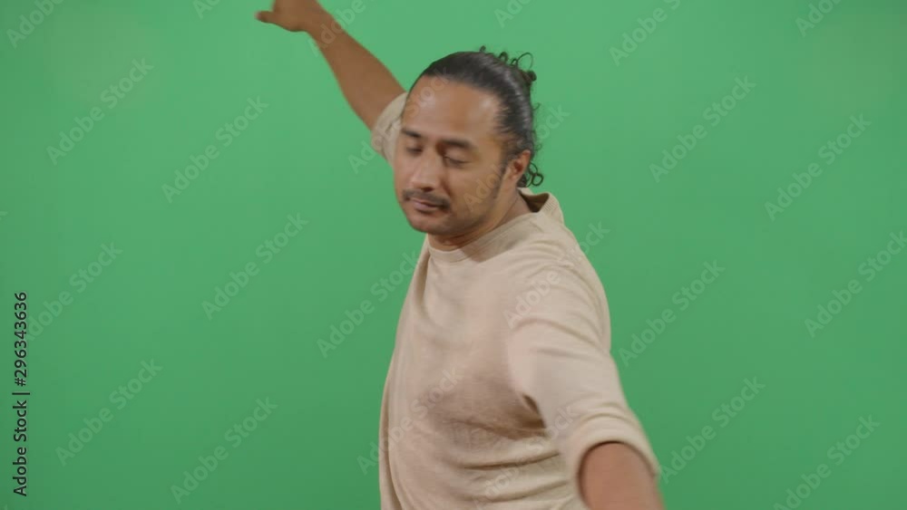 Adult Man Spinning With His Hands Spread Out. Studio Isolated Shot Against Green Screen Background Adult Man Spinning With His Hands Spread Out. Studio Isolated Shot Against Green Screen Background