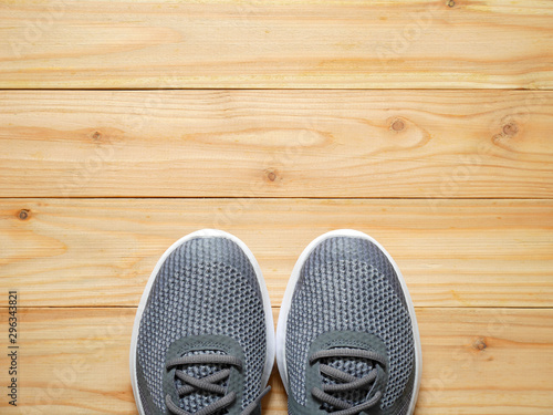 Grey sport shoes on wooden