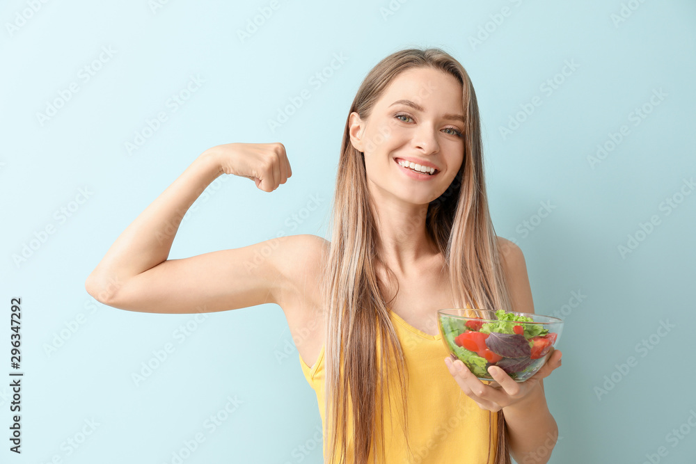 Happy woman with healthy vegetable salad on light background. Diet concept Happy woman with healthy vegetable salad on light background. Diet concept
