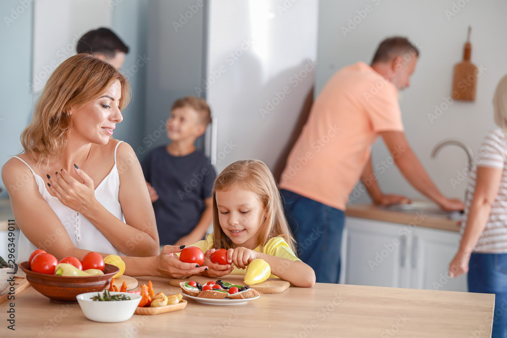 Mother with little daughter cooking in kitchen Mother with little daughter cooking in kitchen