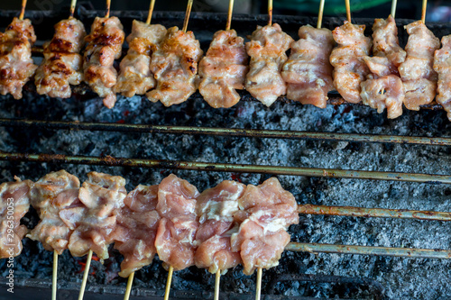Barbecue pork Toast grill or Toast pork with Thai garnish nutrition preparation for cooking. Thai food, Street food. Pork satay grilling on stove or Thai style roasted pork at the market.