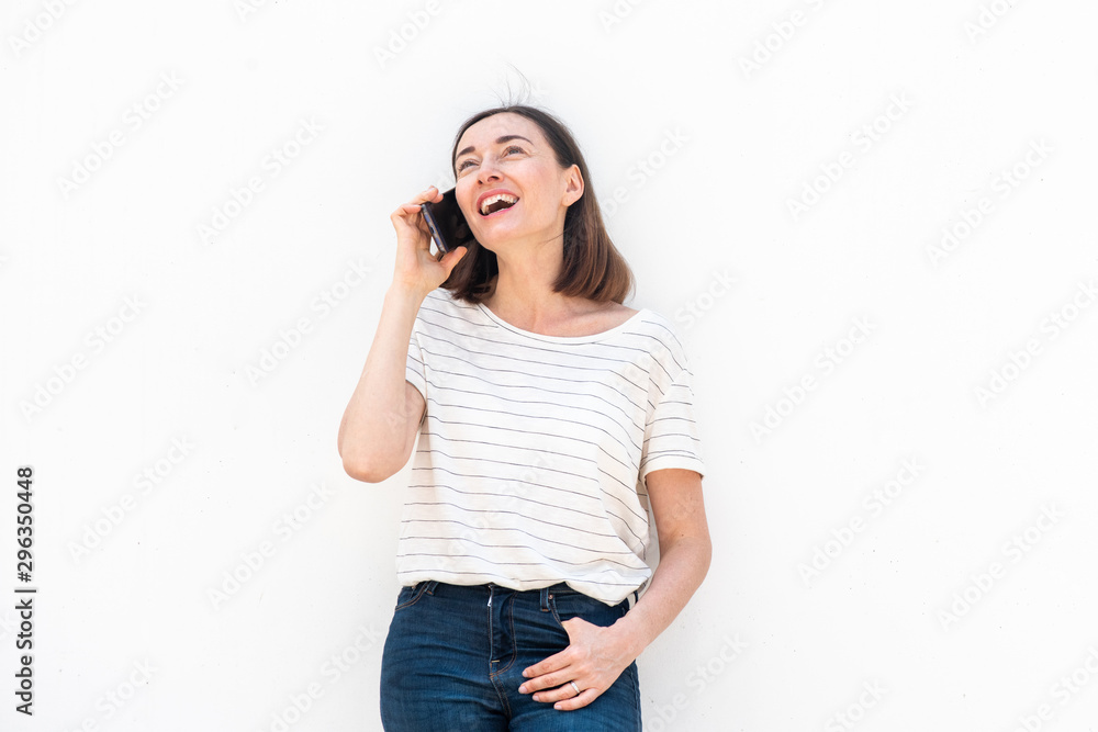 happy middle aged woman talking with cellphone by white background happy middle aged woman talking with cellphone by white background