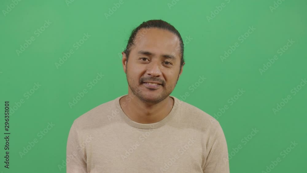 Facial Expression Of A Adult Man Smiling. Studio Isolated Shot Against Green Screen Background Facial Expression Of A Adult Man Smiling. Studio Isolated Shot Against Green Screen Background