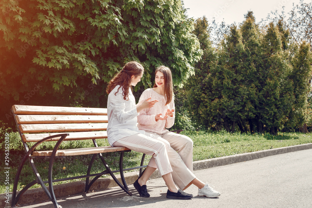 Beautiful two sisters. Women in a summer park Beautiful two sisters. Women in a summer park