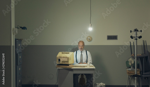 Sad businessman working in a small office