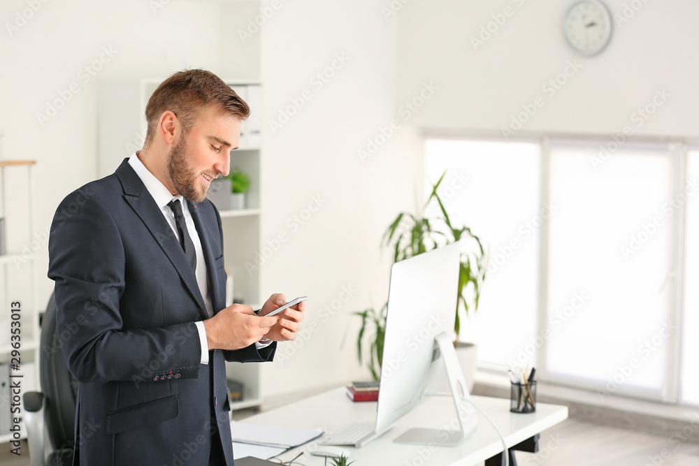 Portrait of handsome businessman with mobile phone in office Portrait of handsome businessman with mobile phone in office