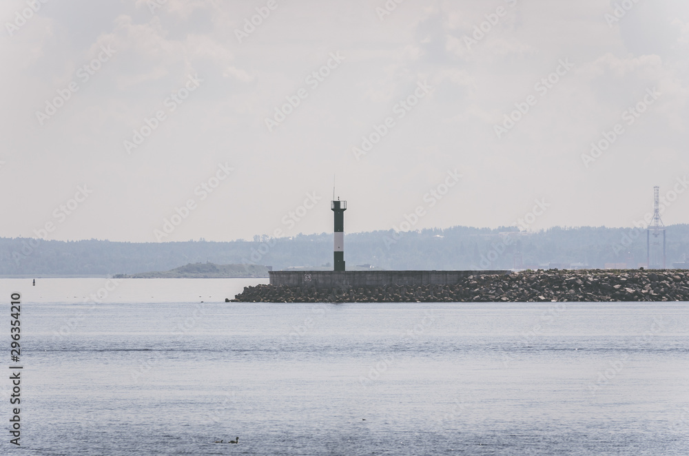 Fototapeta premium White lighthouse in the seaport