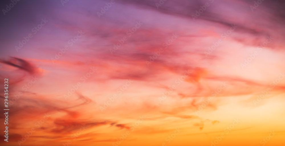 Colorful cloudy sky at sunset. Gradient pink, orange, blue colors. Beautiful sunset