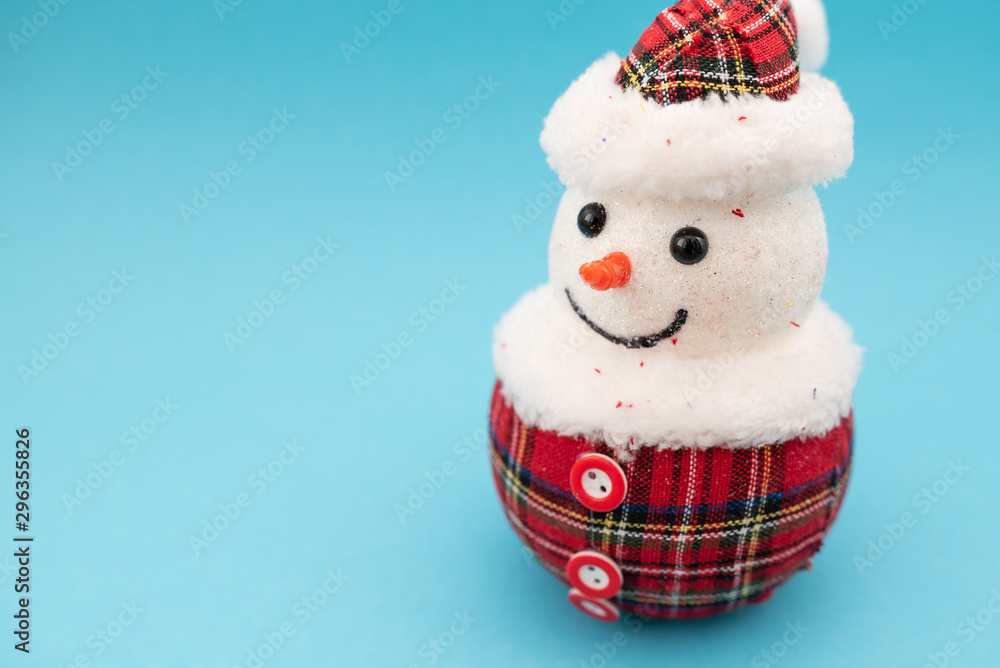 Fototapeta premium Christmas-tree decorations on blue background. Snowman toy