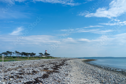 Pebble beach at Helgenæs and the lighthouse 