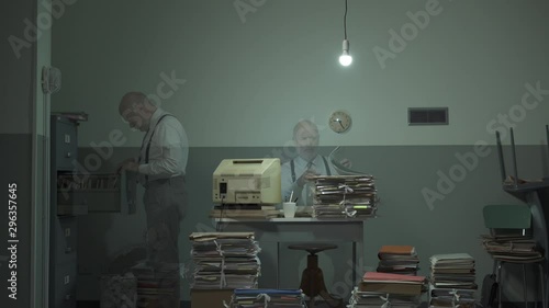 Office worker searching for files in a messy office