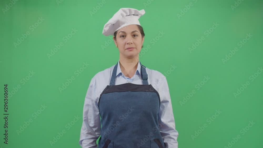 Woman Cook Mouth Cleanning With The Apron. Studio Isolated Shot Against Green Screen Background Woman Cook Mouth Cleanning With The Apron. Studio Isolated Shot Against Green Screen Background