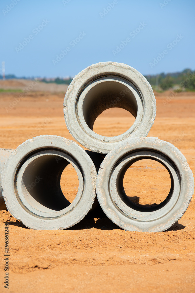Stacked concrete drainage pipes on a building site. Stacked concrete drainage pipes on a building site.