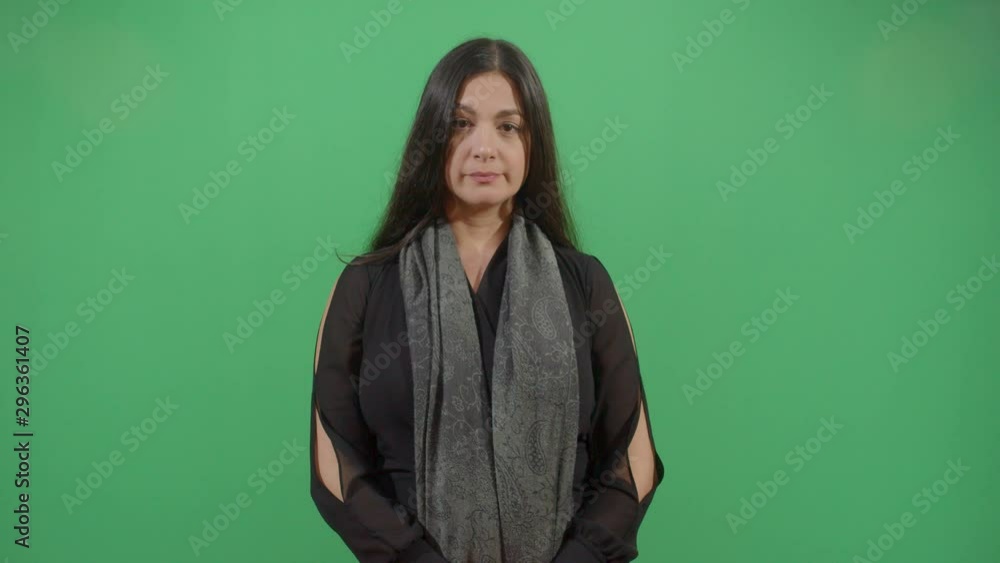 Woman Making An Expression Of Confusion With Face And Arms . Studio Isolated Shot Against Green Screen Background Woman Making An Expression Of Confusion With Face And Arms . Studio Isolated Shot Against Green Screen Background