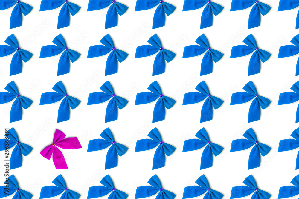 Fototapeta premium Blue bows, one pink on a white background, Christmas pattern, not like everything, unique, against the system.