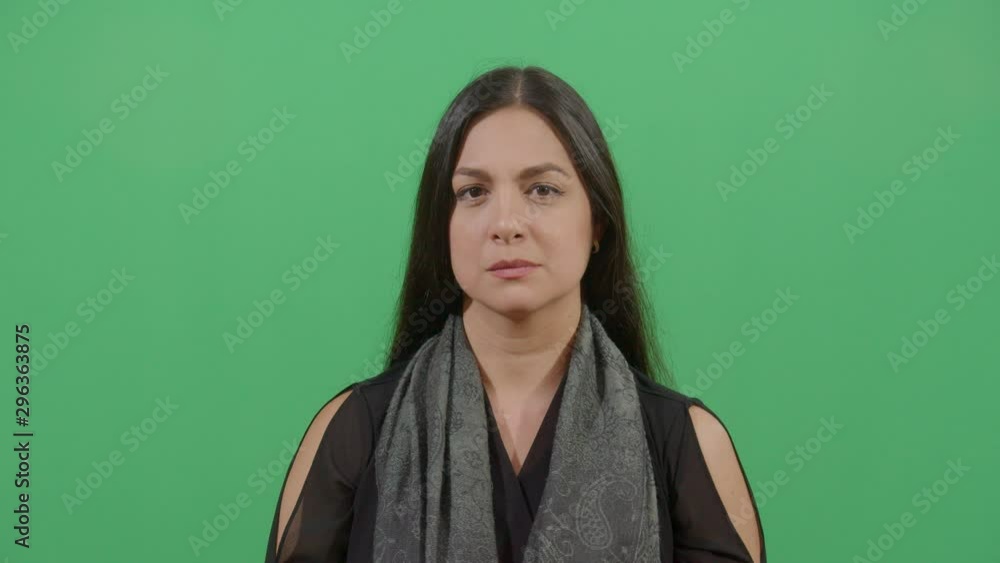 Woman Using Hands As Hearing Device And Facial Expression Of Listening Better. Studio Isolated Shot Against Green Screen Background Woman Using Hands As Hearing Device And Facial Expression Of Listening Better. Studio Isolated Shot Against Green Screen Background
