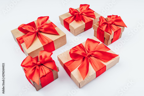 Cardboard gift boxes with red bows on white background.