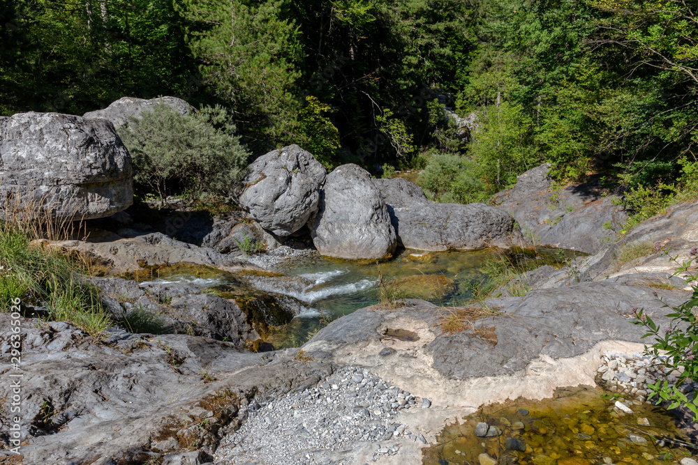 Cold, mountain river flows on a sunny summer day (Greece, Mount Olympus). Cold, mountain river flows on a sunny summer day (Greece, Mount Olympus).