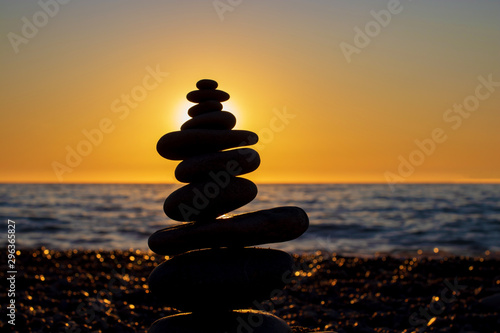 The object of the stones on the beach at sunset. Zen concept. Sunset. Silhouette of stones against the sunset sky