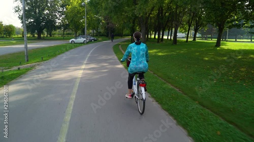Wallpaper Mural Woman riding a bicycle during sunrise at park, Zagreb, Croatia. Torontodigital.ca