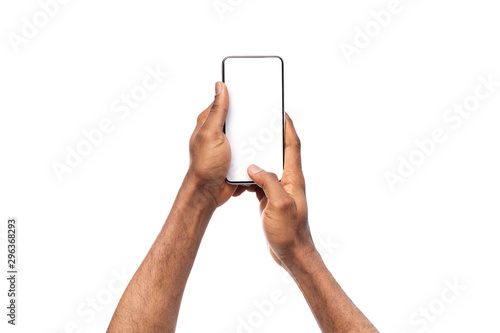 Black man's hands holding cellphone with blank screen, taking photo