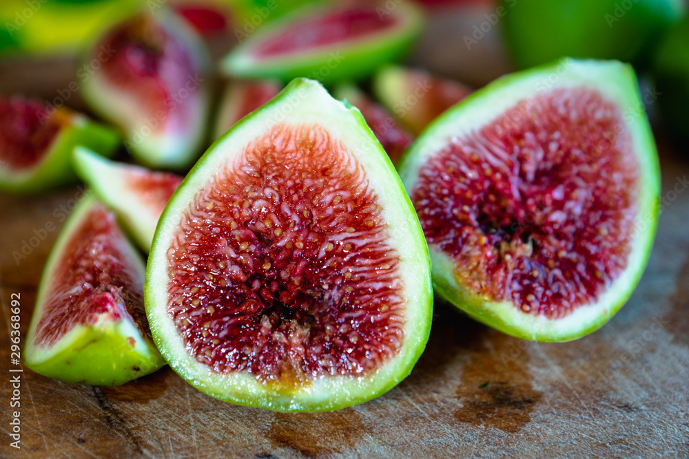 Fig - fresh figs and sliced fig fruits close-up on cutting board Fig - fresh figs and sliced fig fruits close-up on cutting board