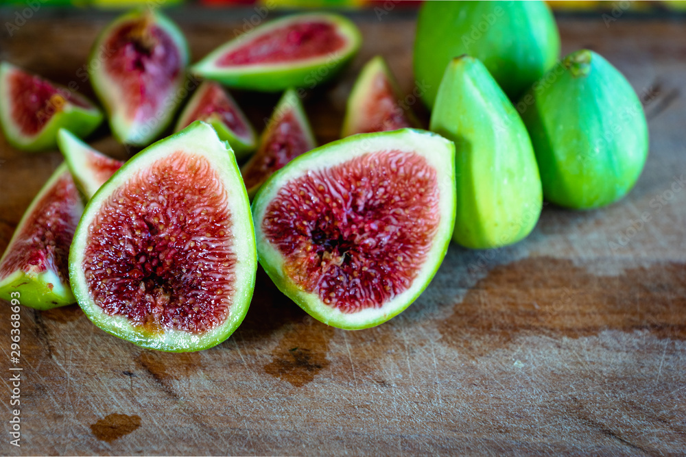Fig - fresh figs and sliced fig fruits close-up on cutting board