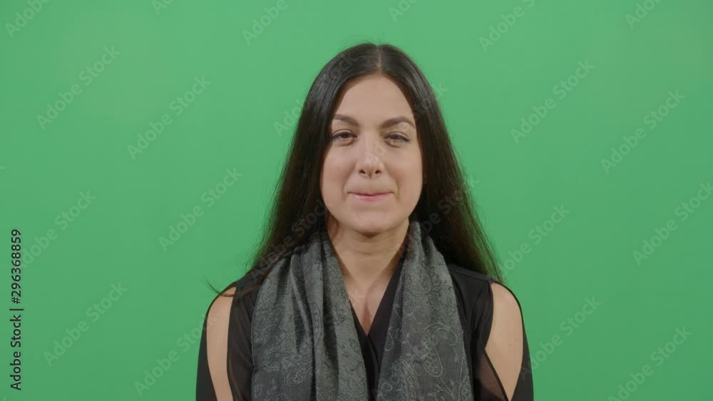 Woman Licking Lips At The Viewer Expressing Desire Or The Taste Of Some Delicious Food. Studio Isolated Shot Against Green Screen Background Woman Licking Lips At The Viewer Expressing Desire Or The Taste Of Some Delicious Food. Studio Isolated Shot Against Green Screen Background