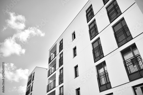  Fragment of a facade of a building with windows and balconies. Modern home with many flats. Black and white. © Grand Warszawski