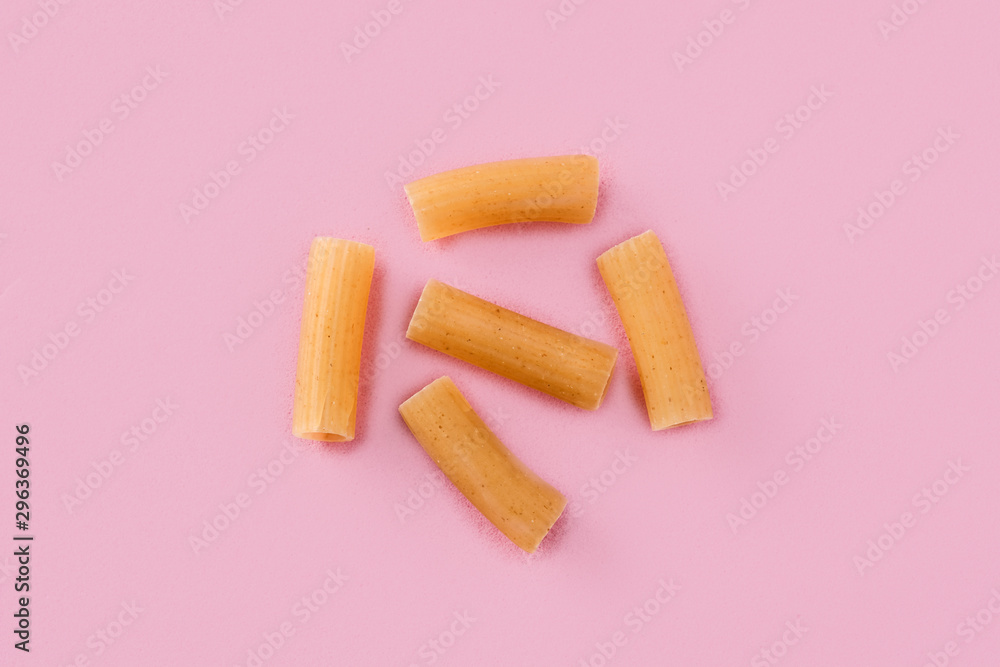 Fresh macaroni pasta isolated on pink background