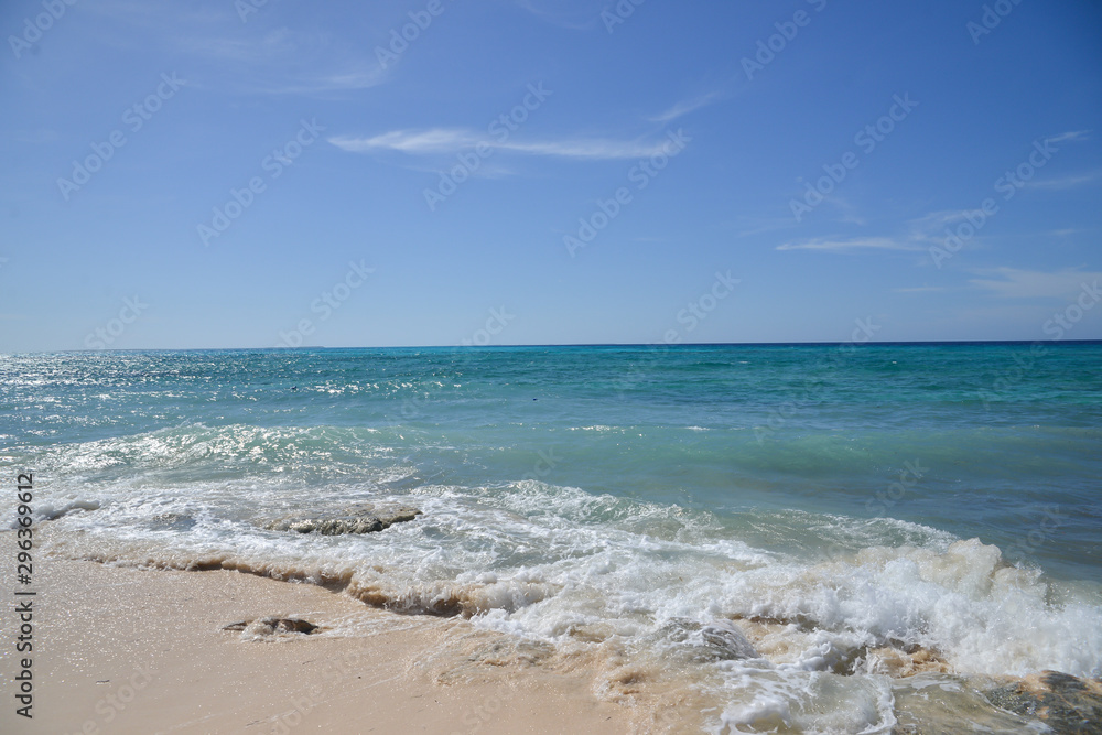 Tranquility -beautiful tropical beach and ocean with blue sky , perfect setting for a vacation