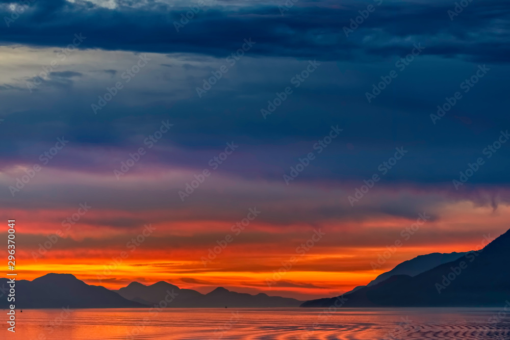 Sunrise over Ocean, Silhouetted Mountains