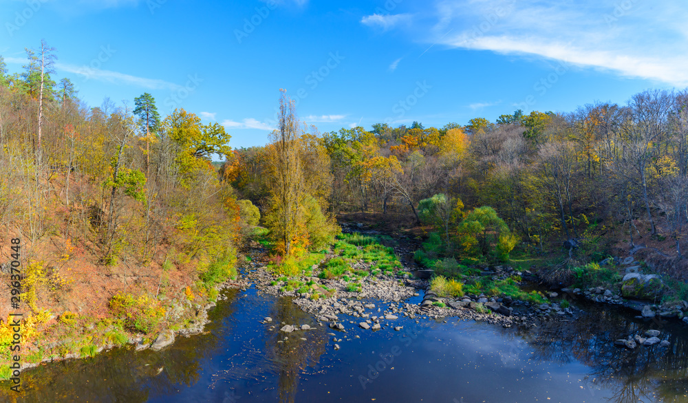 Panorama of autumn landscape with colorful forest, river and forest trails