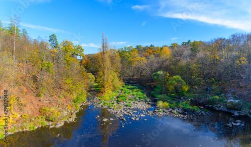 Panorama of autumn landscape with colorful forest  river and forest trails