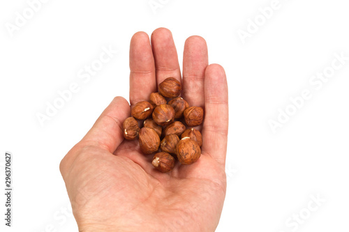 Hazelnuts in hand on white isolated background