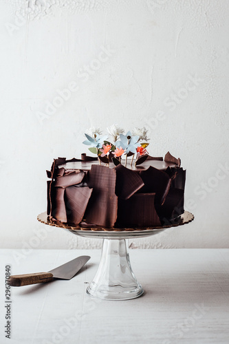 Close up view of chocolate truffle cake with cake stand and spatula photo
