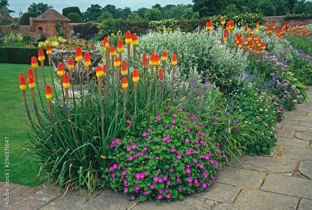 An impressive and colourful terraced flower border at an English country house garden An impressive and colourful terraced flower border at an English country house garden