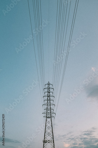 Low angle view of electricity grid against clear sky