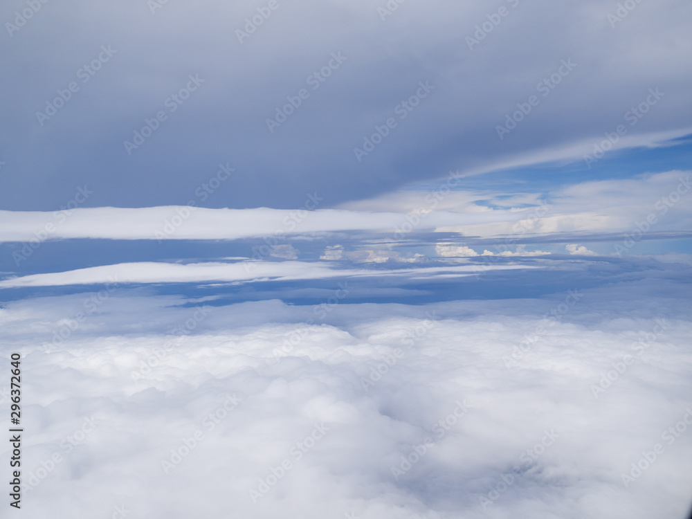 Clouds from airplane window with blue sky Clouds from airplane window with blue sky
