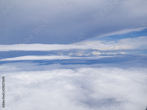 Clouds from airplane window with blue sky © Lucky7Trader