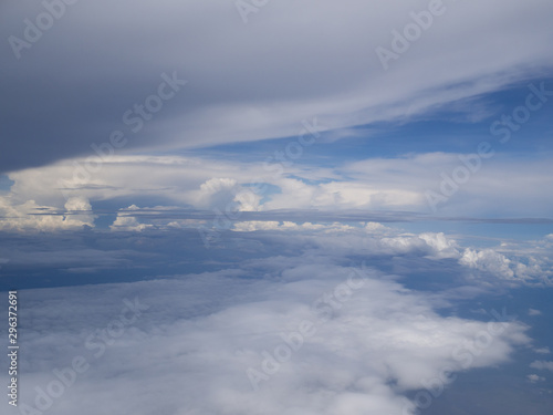 Clouds from airplane window with blue sky