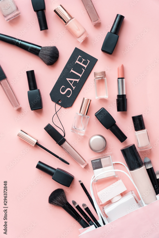 Makeup cosmetic perfume women products accessory pouring from shopping bag  on pink flat lay background, beauty products cheap discount retail offer online  purchase, top view above vertical photo Stock Photo | Adobe