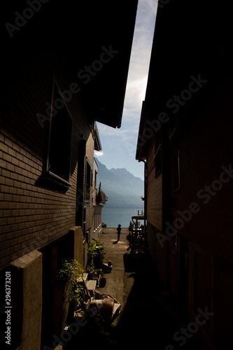 Rear view of boy in passage between houses