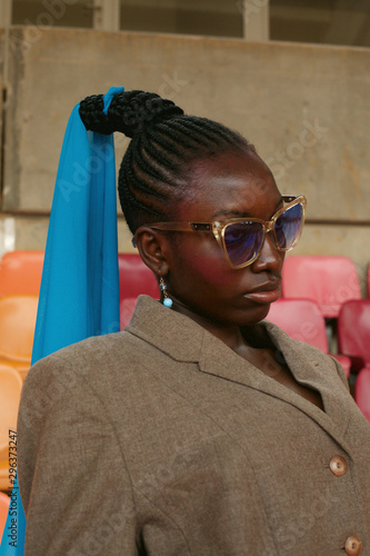 Woman in jacket standing in stadium photo