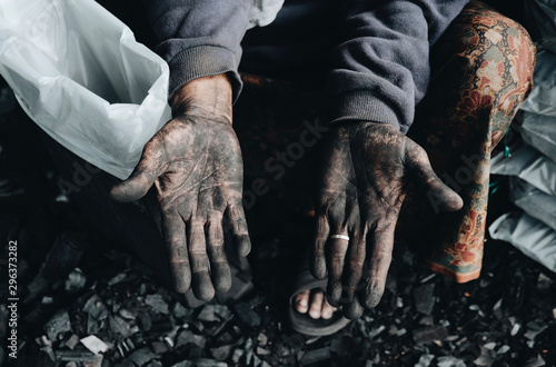 Hands of working miner